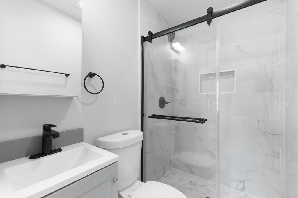 128 Bristol Boulevard San Leandro, CA 94577 - Photo 12 of 32 a bathroom with a shower toilet and sink