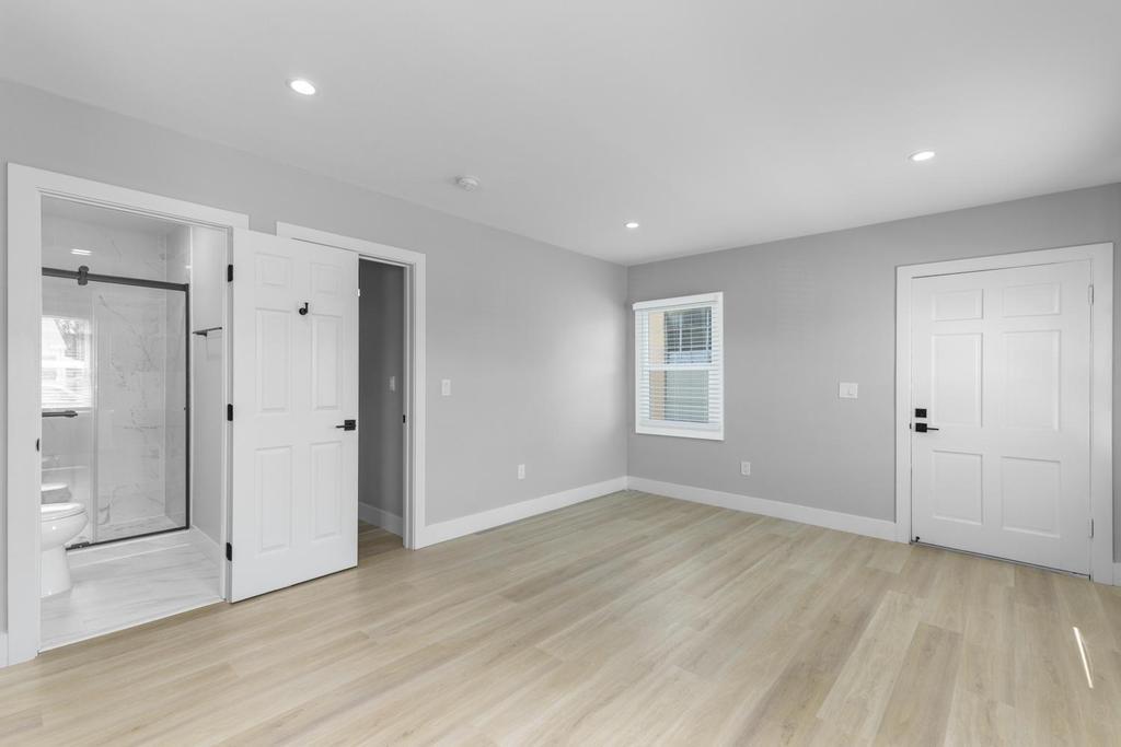 128 Bristol Boulevard San Leandro, CA 94577 - Photo 14 of 32 an empty room with wooden floor and windows