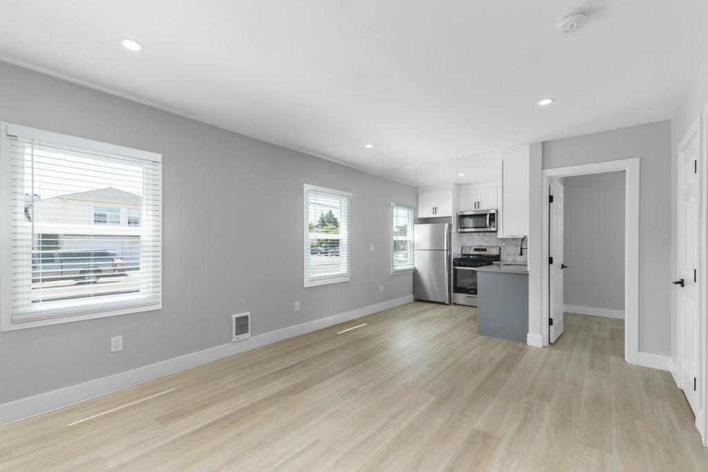128 Bristol Boulevard San Leandro, CA 94577 - Photo 20 of 32 a kitchen with stainless steel appliances a refrigerator and a wooden floor