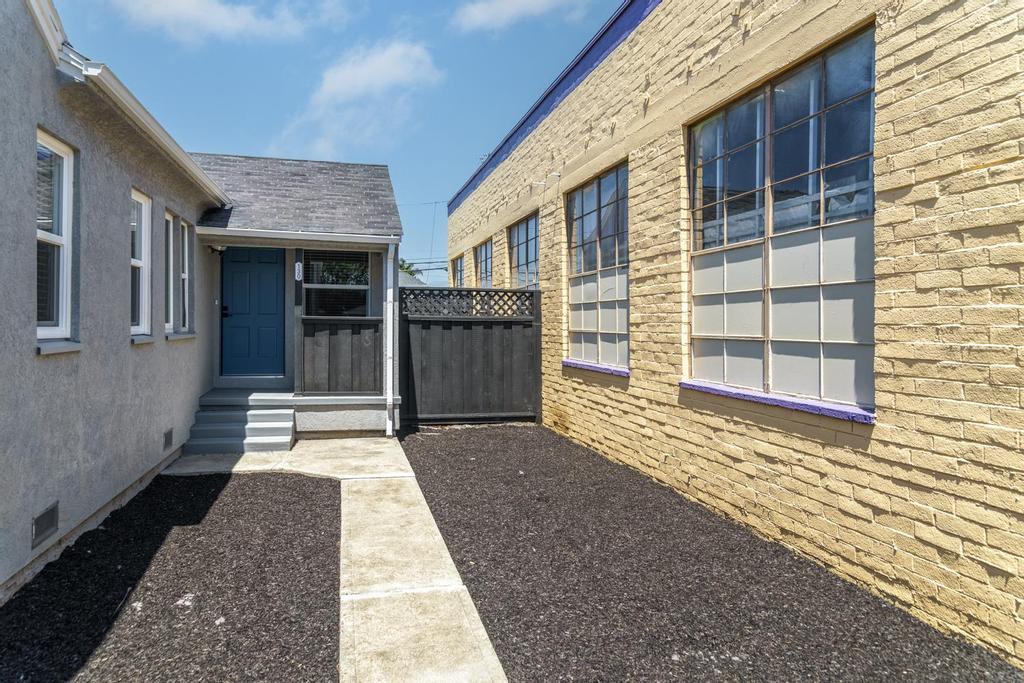 128 Bristol Boulevard San Leandro, CA 94577 - Photo 3 of 32 a view of a brick house with large windows