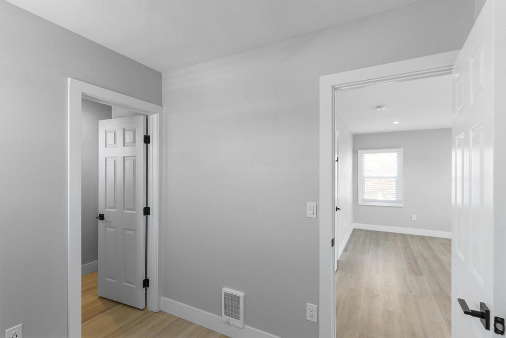 128 Bristol Boulevard San Leandro, CA 94577 - Photo 8 of 32 a view of a hallway with wooden floor