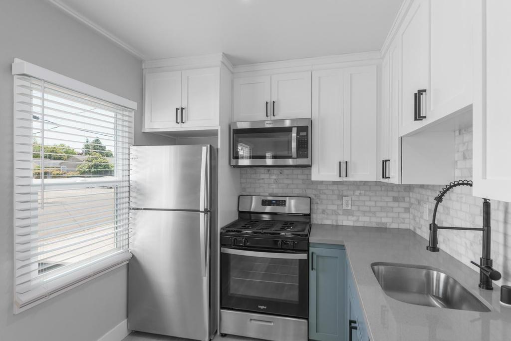 128 Bristol Boulevard San Leandro, CA 94577 - Photo 9 of 32 a kitchen with stainless steel appliances granite countertop a refrigerator sink and stove