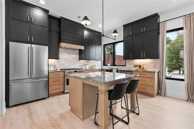 a kitchen with a refrigerator a stove a sink and a microwave