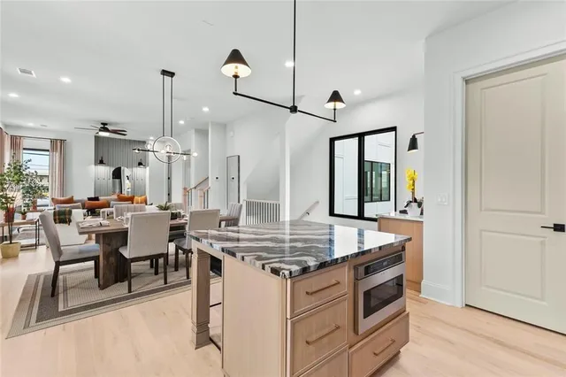 a view of kitchen island with stainless steel appliances kitchen island table and chairs