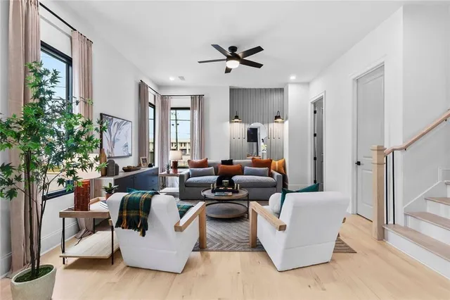 a living room with fireplace furniture and a potted plant