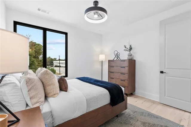 a bedroom with a bed and a window