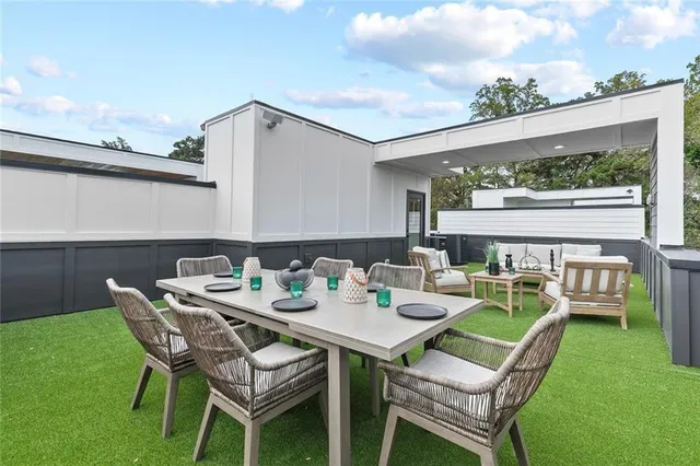 a dining room with furniture and a garden