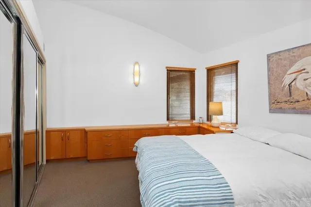 a bedroom with a bed and lamp