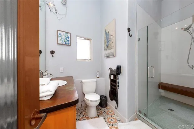 a bathroom with a toilet a sink and shower