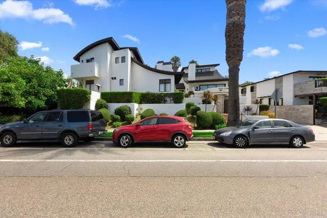a view of cars parked in front of a house