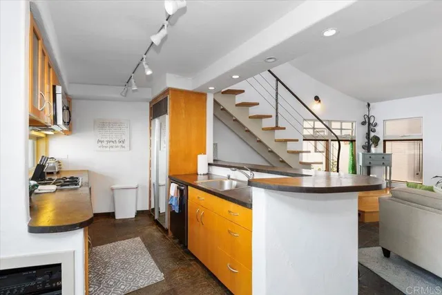 a kitchen with stainless steel appliances granite countertop a sink and stove