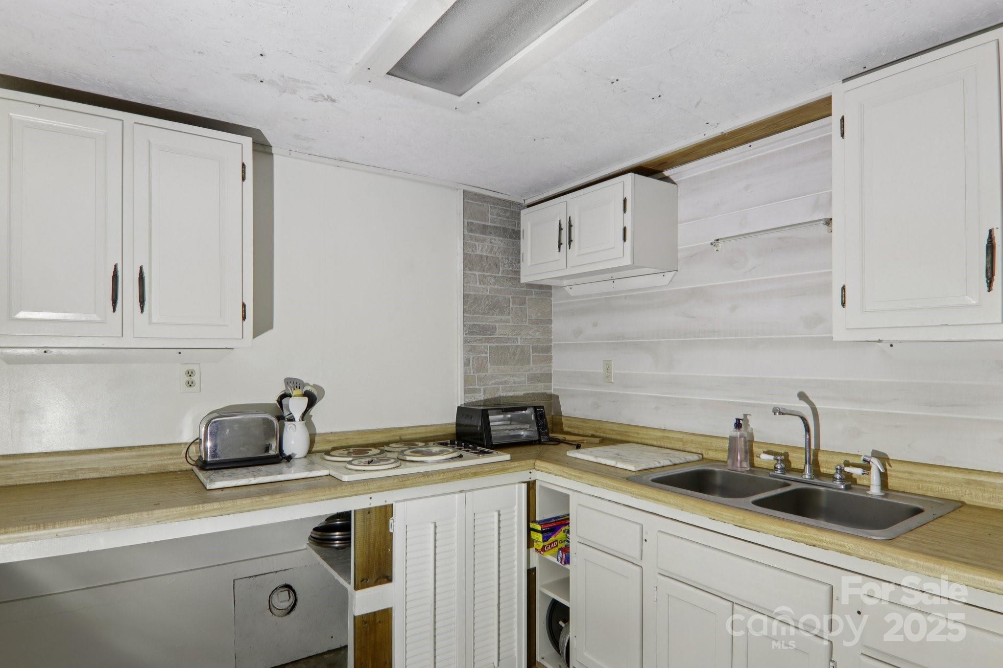 190 Turkey Creek Road Clyde, NC 28721 - Photo 20 of 48 a kitchen with a sink and cabinets