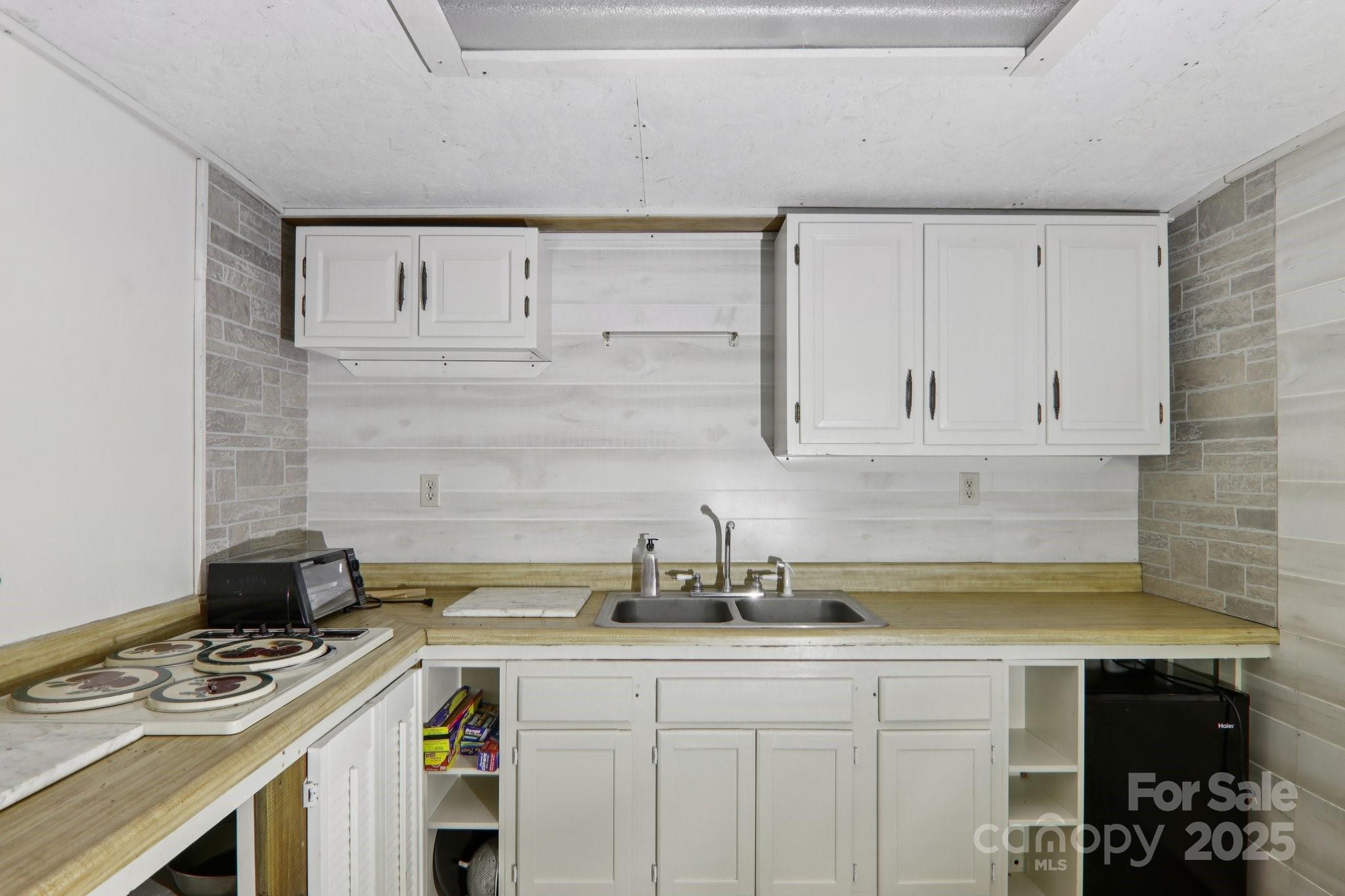 190 Turkey Creek Road Clyde, NC 28721 - Photo 21 of 48 a kitchen with a sink stove and cabinets
