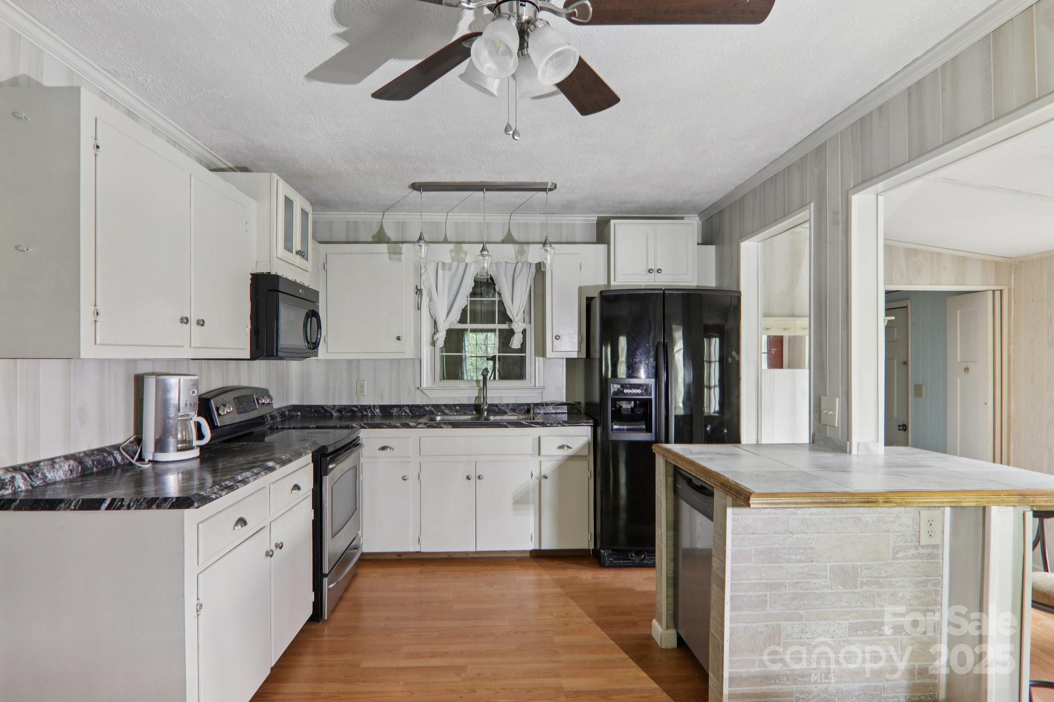 190 Turkey Creek Road Clyde, NC 28721 - Photo 24 of 48 a large kitchen with stainless steel appliances granite countertop a stove refrigerator and cabinets