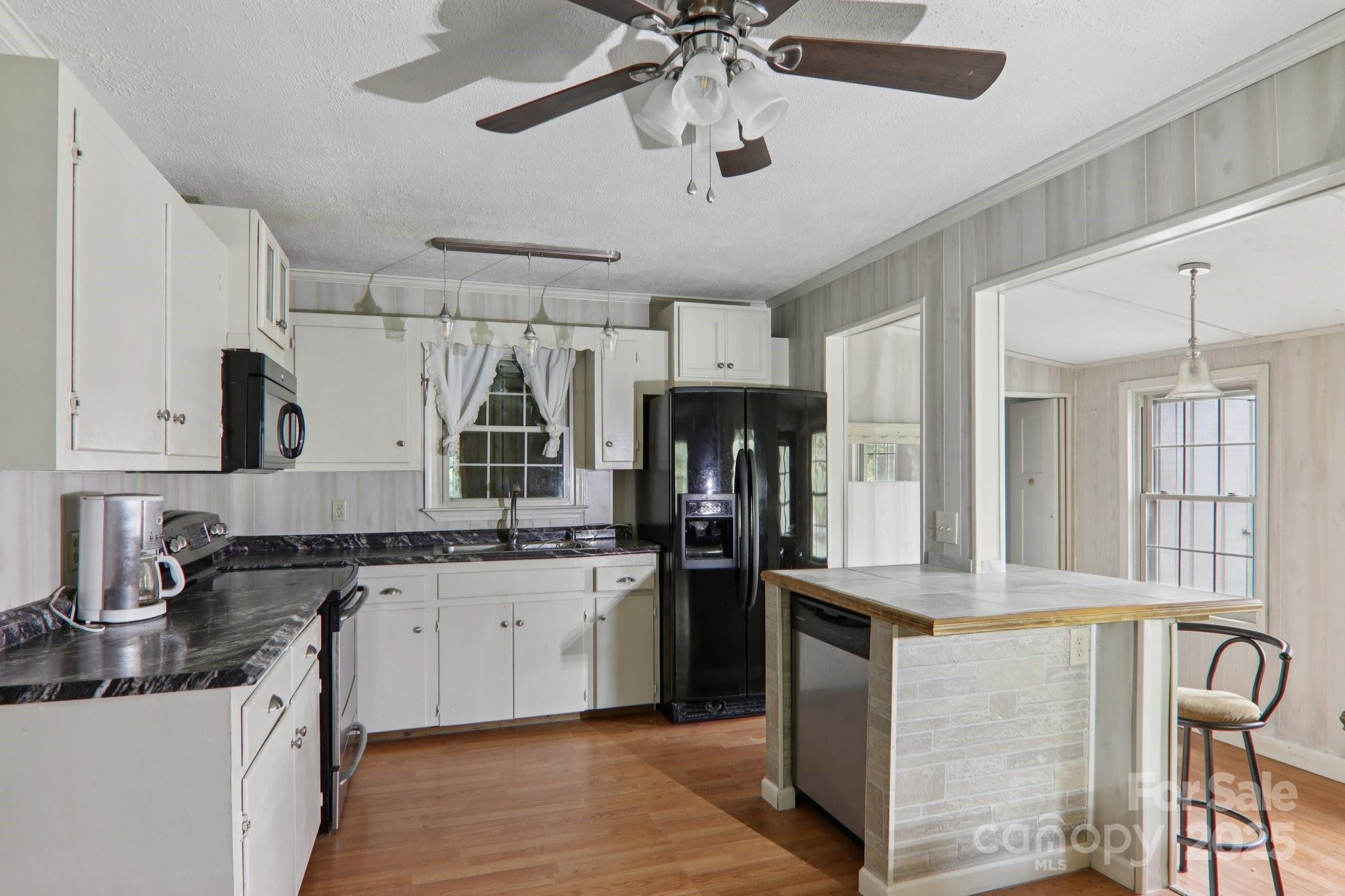 190 Turkey Creek Road Clyde, NC 28721 - Photo 25 of 48 a kitchen with granite countertop a sink appliances cabinets and furniture