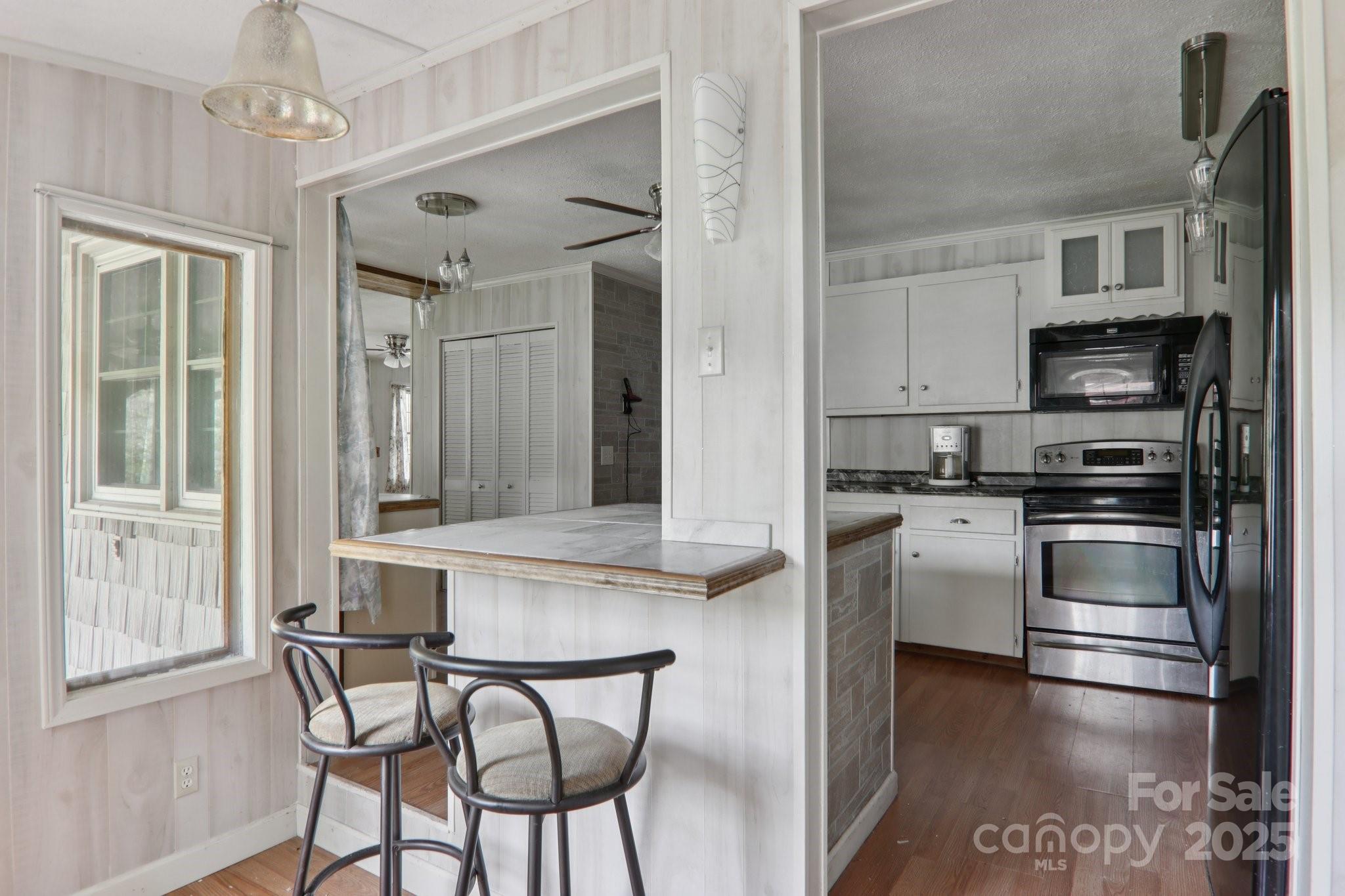 190 Turkey Creek Road Clyde, NC 28721 - Photo 27 of 48 a kitchen with stainless steel appliances a stove a refrigerator and a stove top oven