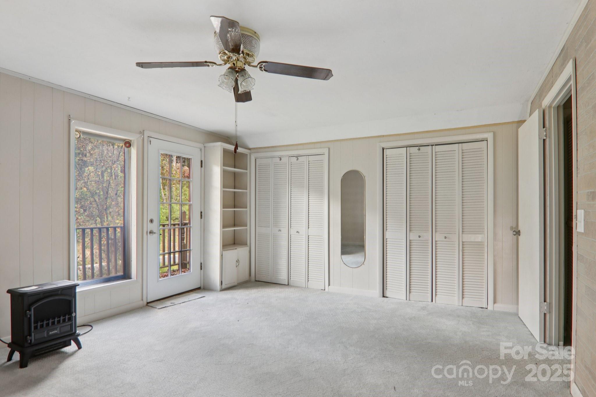 190 Turkey Creek Road Clyde, NC 28721 - Photo 37 of 48 a view of a livingroom with a chandelier fan and windows