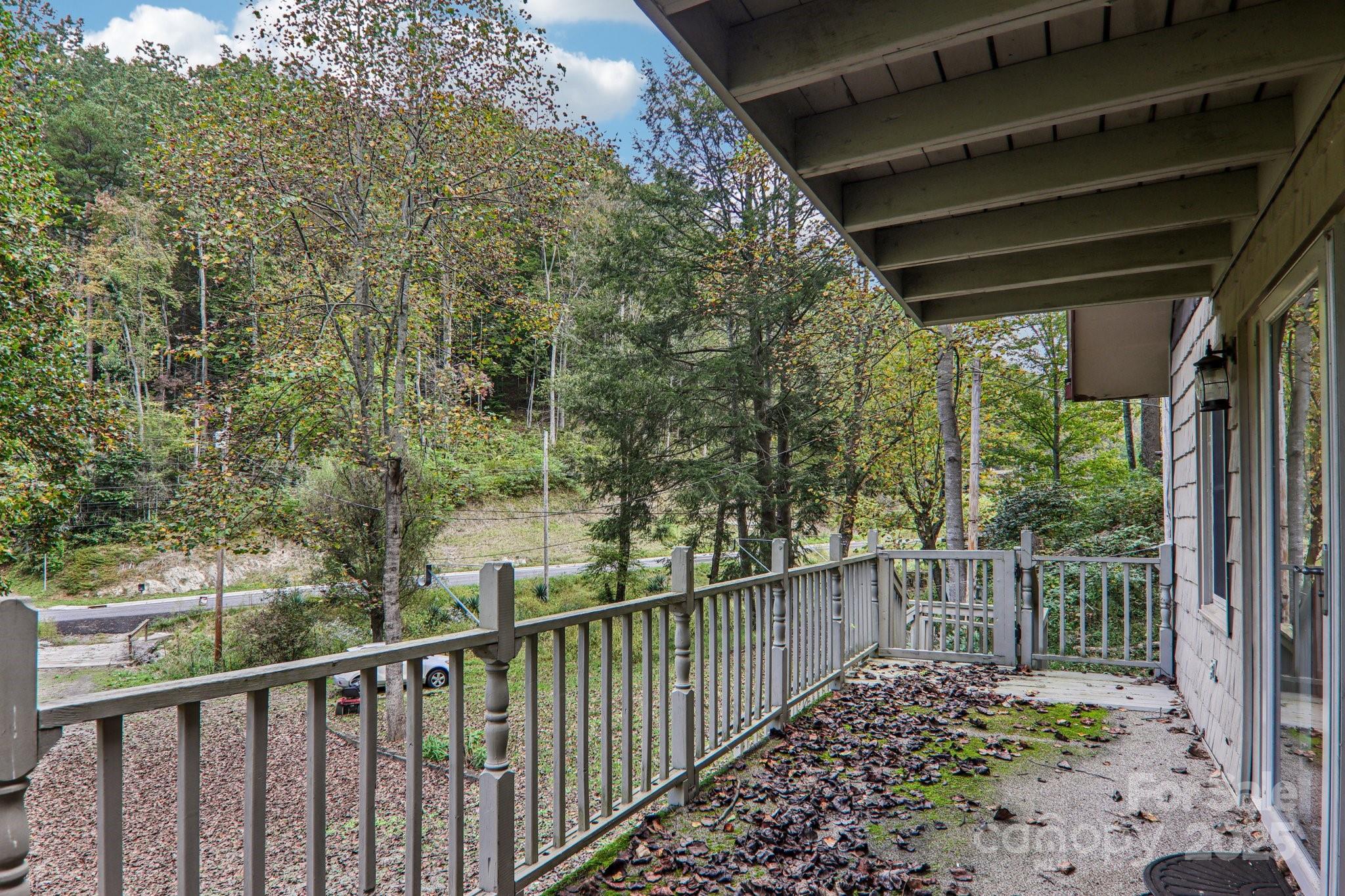 190 Turkey Creek Road Clyde, NC 28721 - Photo 45 of 48 a view of a pathway of a house with a large window and wooden fence