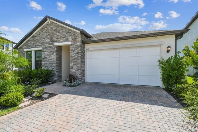 a kitchen with stainless steel appliances granite countertop a stove refrigerator sink and cabinets