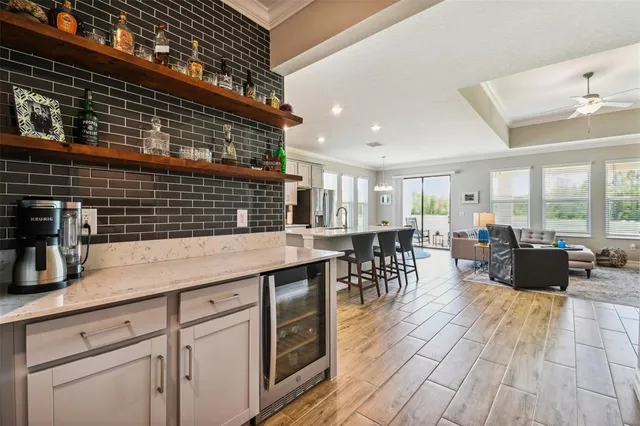a bathroom with a granite countertop sink a mirror and shower