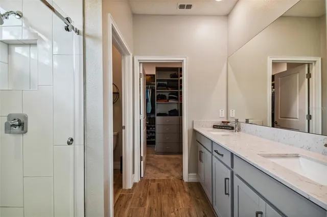 a view of a swimming pool with a chairs and table in the patio