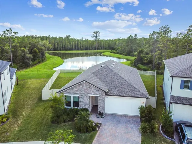 an aerial view of residential houses with outdoor space and swimming pool