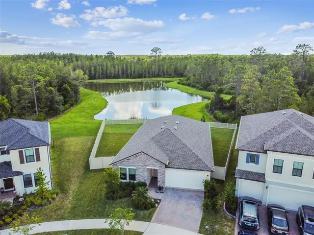 a front view of a house with a garden and plants