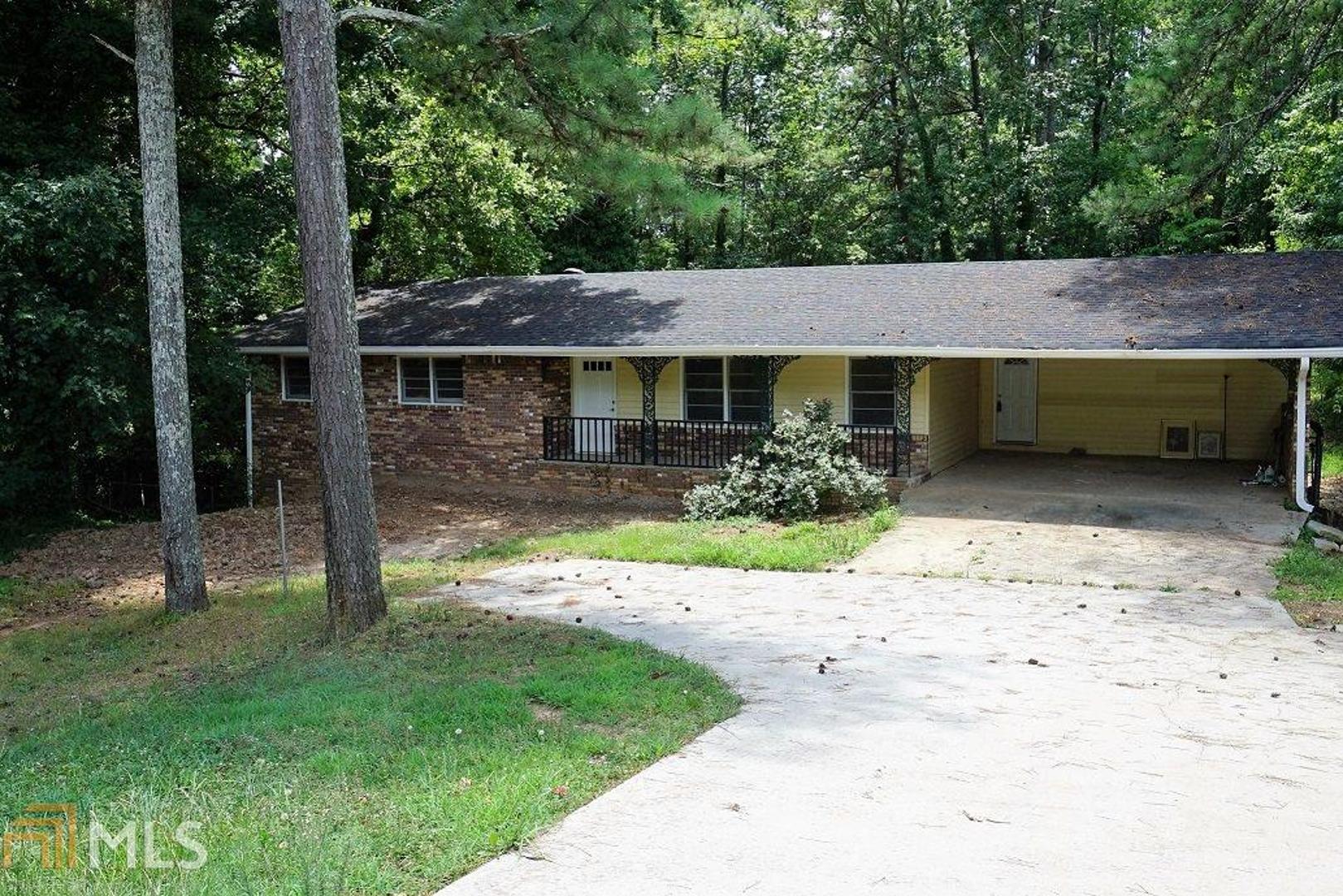 695 Rockbridge Road Southwest Norcross, GA 30093 - Photo 1 of 1 a front view of a house with a garden and yard