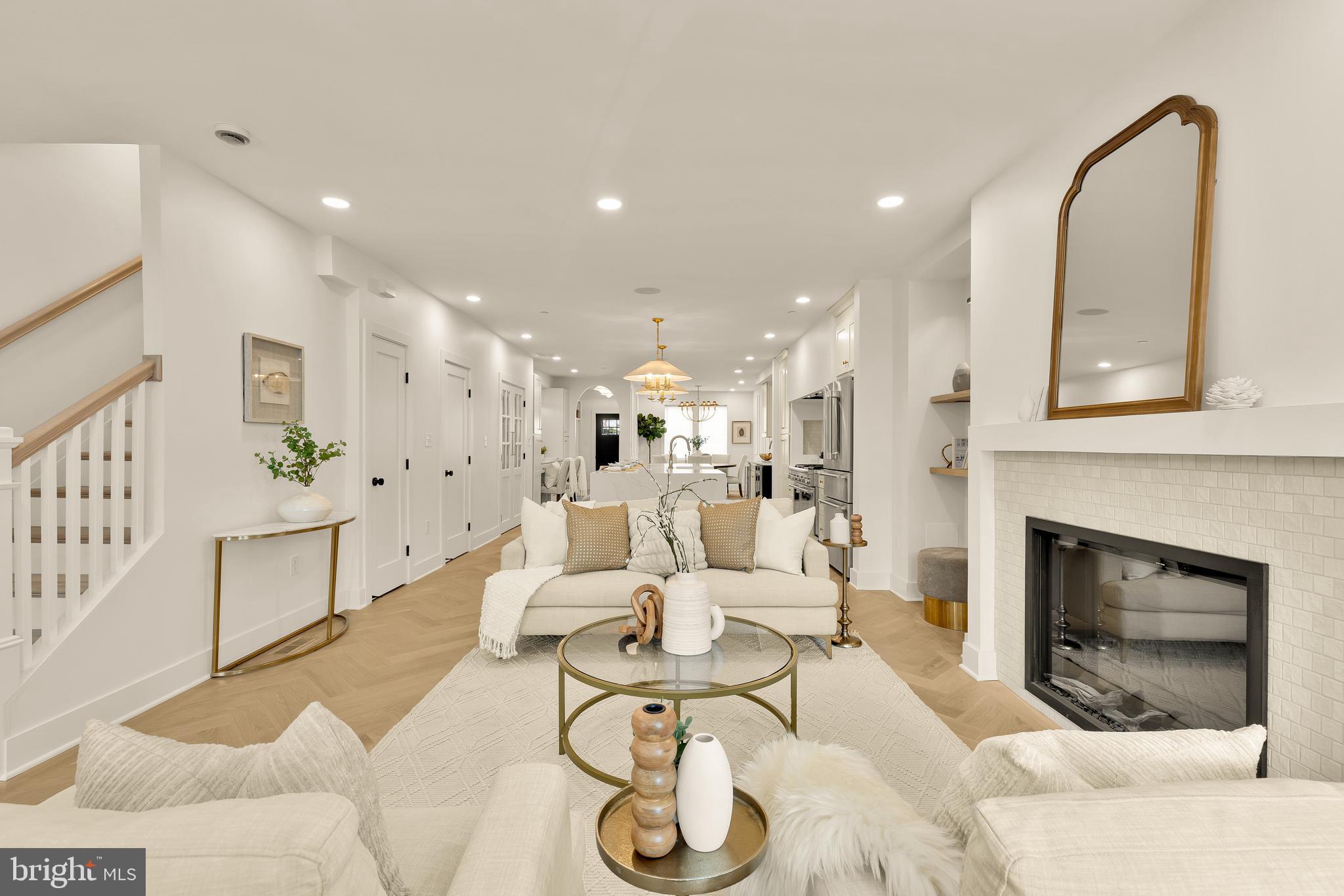 1706 Bay Street Southeast Washington, DC 20003 - Photo 6 of 59 a living room with furniture a fireplace and a chandelier