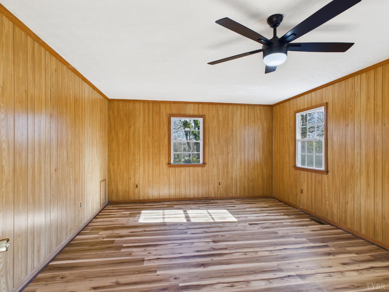 203 Juniper Cliff Road Brookneal, VA 24528 - Photo 12 of 44 a view of a livingroom with wooden floor and a ceiling fan