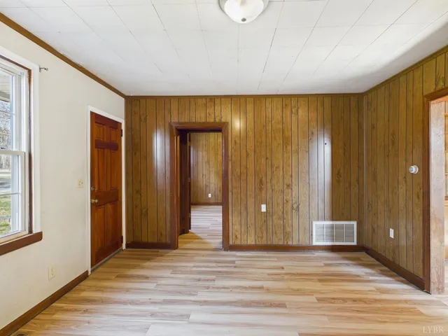 a view of a livingroom with wooden floor and a ceiling fan