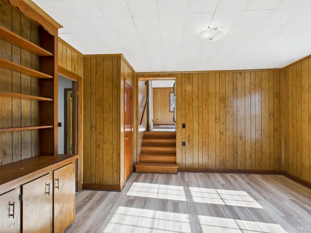 a view of an entryway with wooden floor and a cabinet