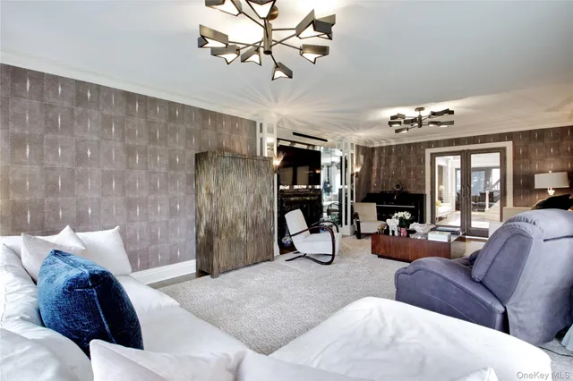 a living room with furniture and a chandelier