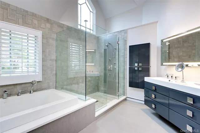 a bathroom with a tub sink and shower