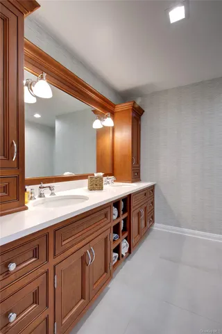a spacious bathroom with a double vanity sink and a mirror