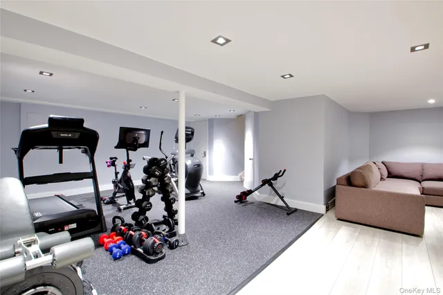 a living room with furniture and gym equipment