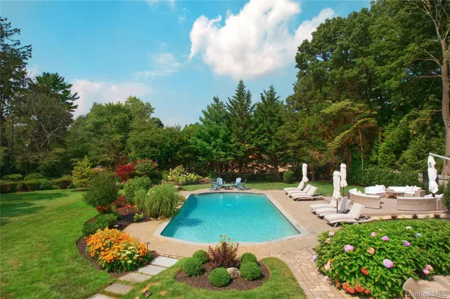 a view of a backyard with sitting area