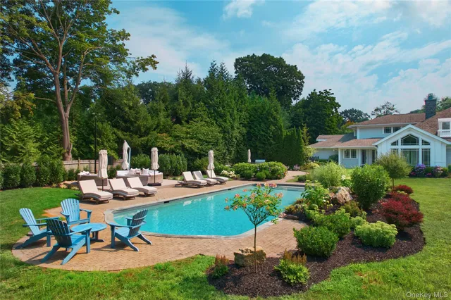 a view of a house with backyard sitting area and garden