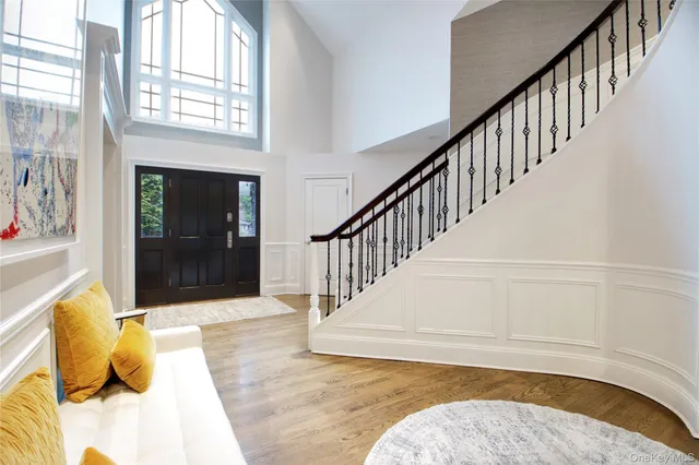 a view of entryway and hall with wooden floor