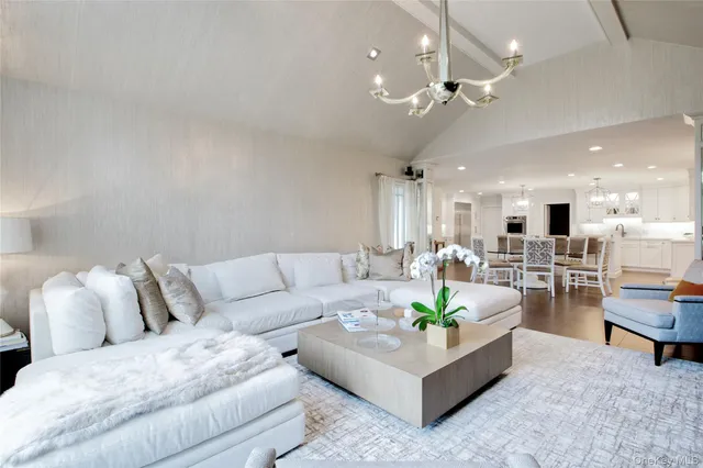 a living room with furniture and a chandelier