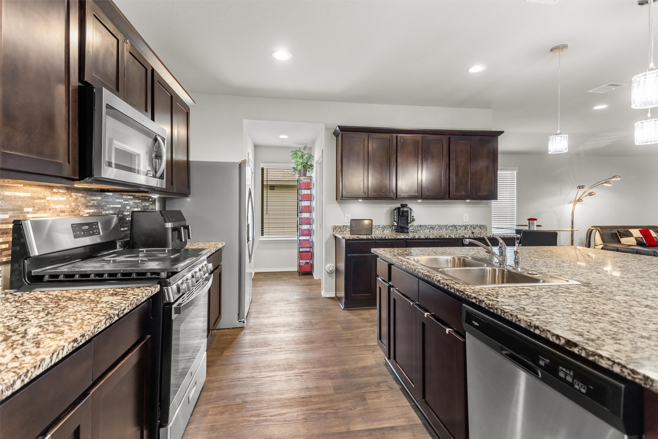 1711 Martin Spring Lane Rosenberg, TX 77469 - Photo 2 of 24 Beautiful Kitchen features granite countertops, rich cabinetry, and stainless steel appliances.