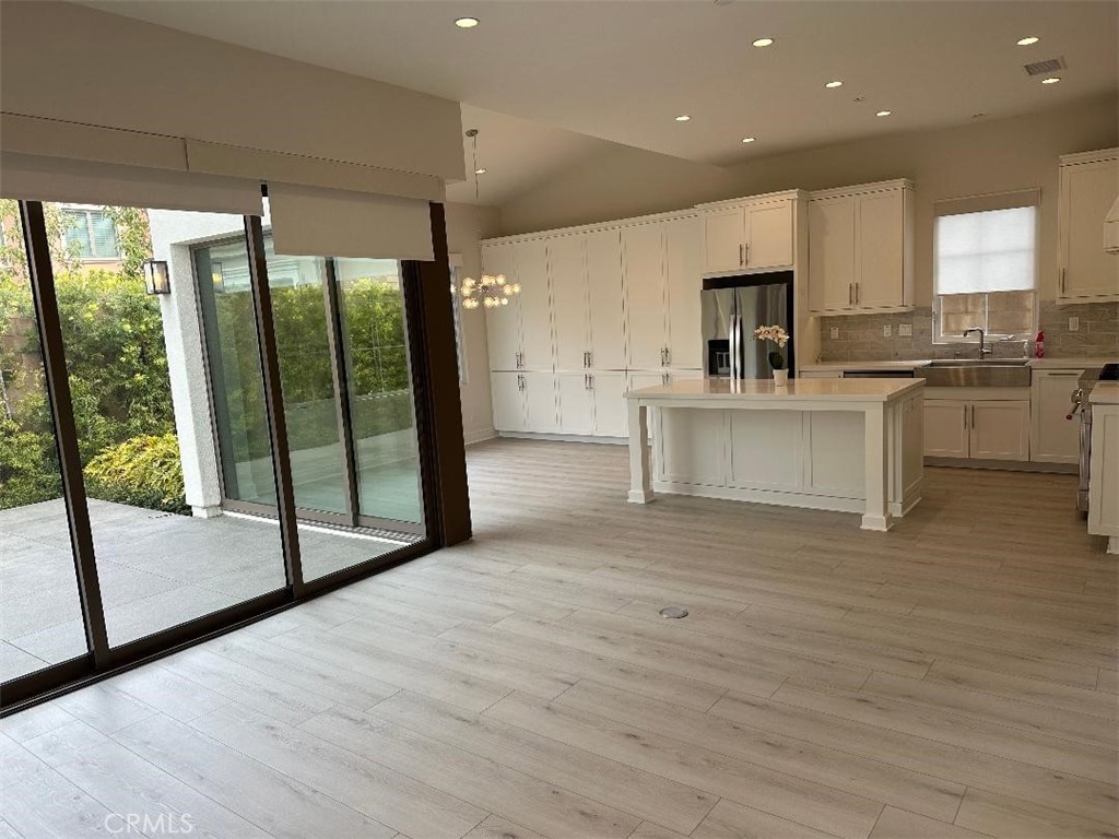 104 San Benito Irvine, CA 92618 - Photo 11 of 19 a view of kitchen with stainless steel appliances granite countertop a stove top oven a sink and cabinets