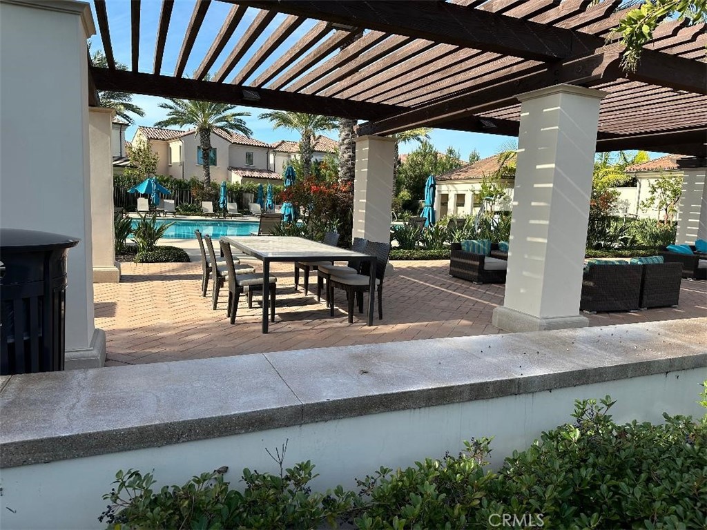 104 San Benito Irvine, CA 92618 - Photo 18 of 19 a patio with table and chairs and potted plants