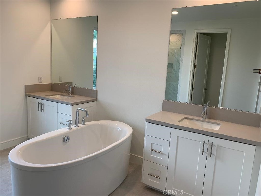 104 San Benito Irvine, CA 92618 - Photo 3 of 19 a white bath tub sitting in a bathroom