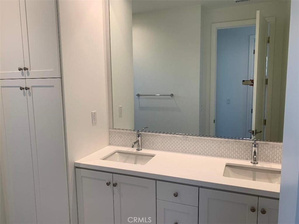 104 San Benito Irvine, CA 92618 - Photo 6 of 19 a bathroom with a sink and a mirror
