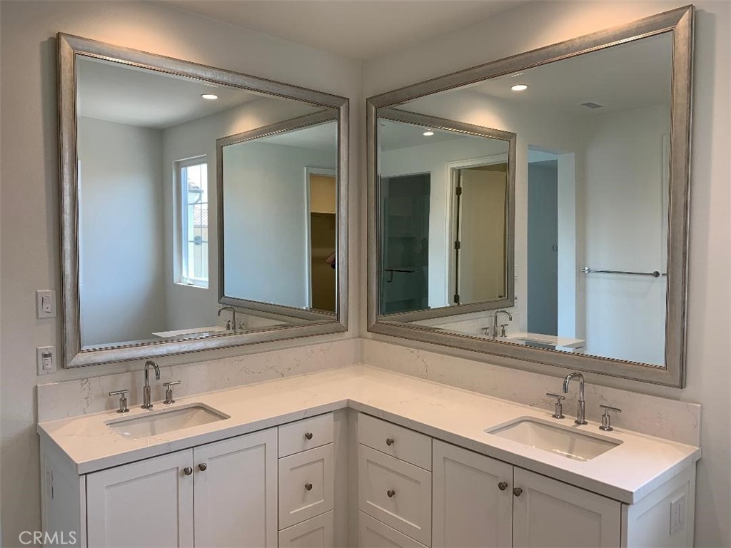 104 San Benito Irvine, CA 92618 - Photo 7 of 19 a bathroom with double sink and a mirror