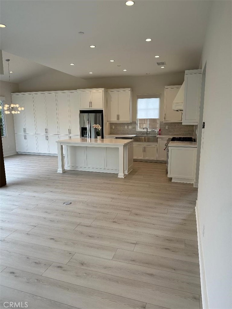 104 San Benito Irvine, CA 92618 - Photo 9 of 19 a living room with kitchen island furniture and a kitchen view