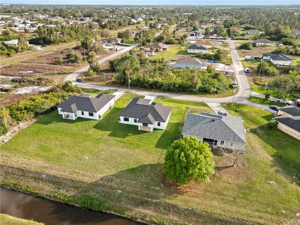 459 Paddock Street Lehigh Acres, FL 33974 - Photo 3 of 16 an aerial view of residential houses with outdoor space