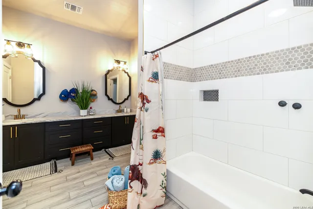 a bathroom with a tub sink and mirror