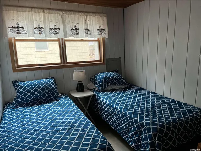 a bedroom with bed and window